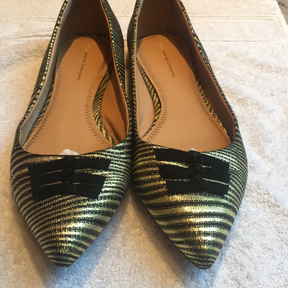 Anthropologie gold and black flats